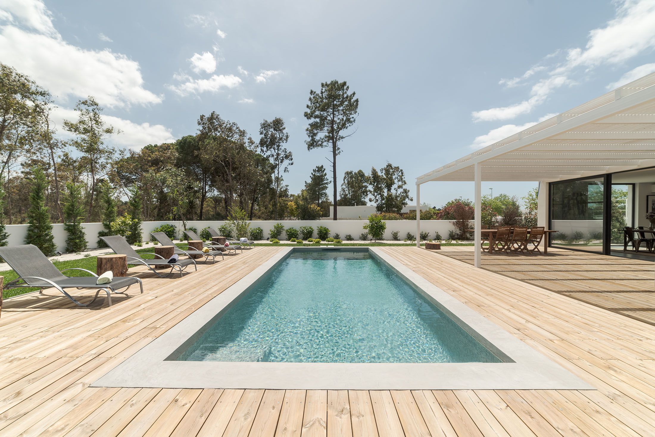 Pool Deck In Residential Backyard With Wooden Deck Boards