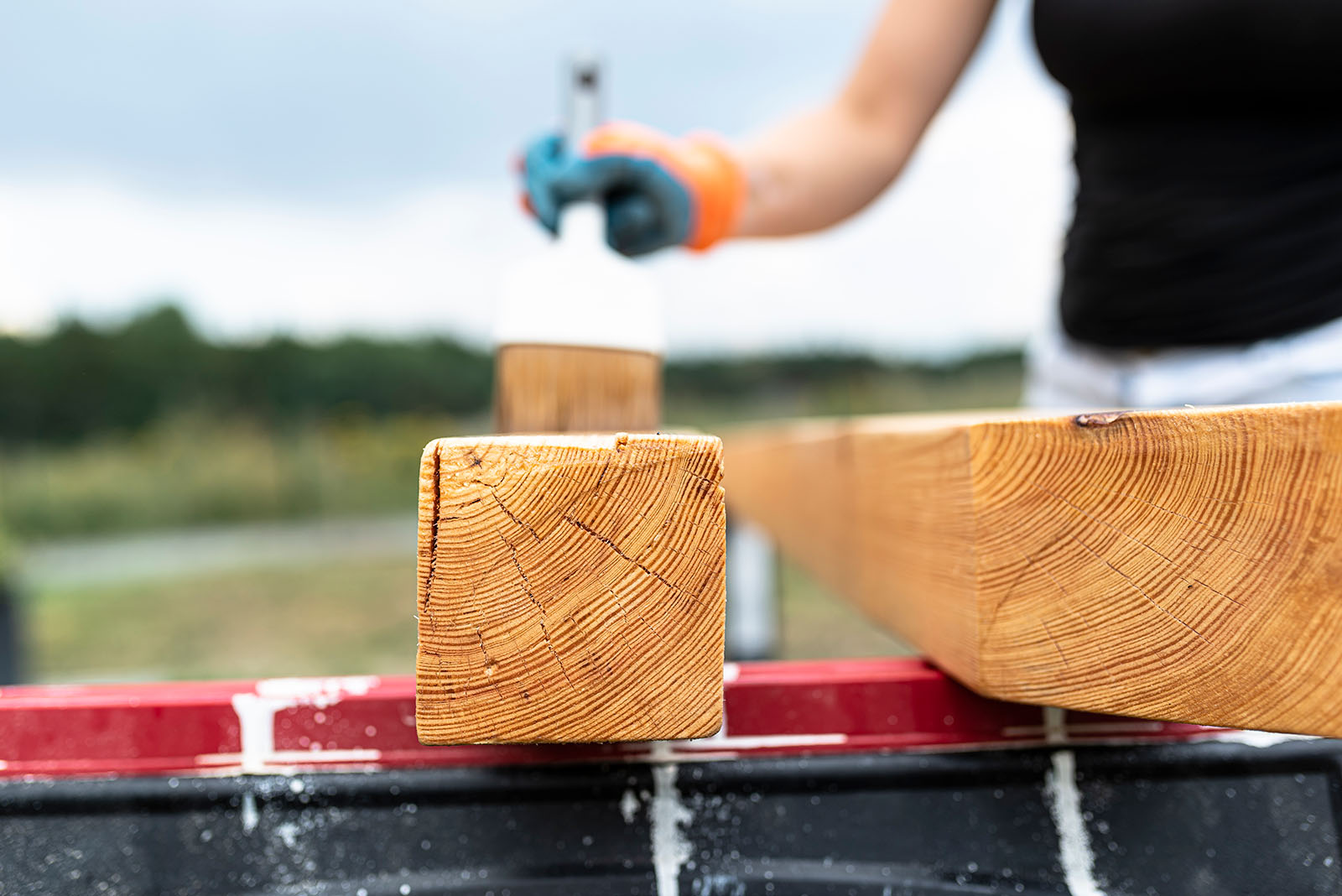 Raw Wooden Beams For Deck Construction With Woman